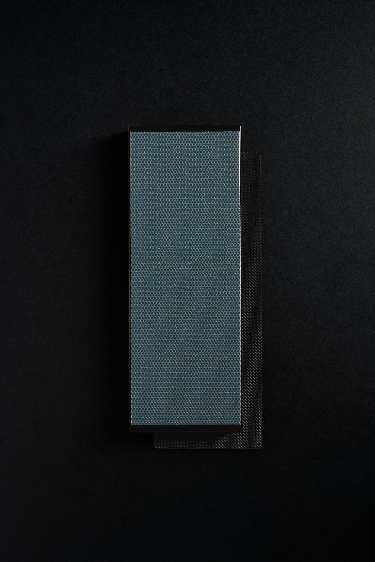 Regular Zen-Wu diamond flattening stone, full face on a dark background