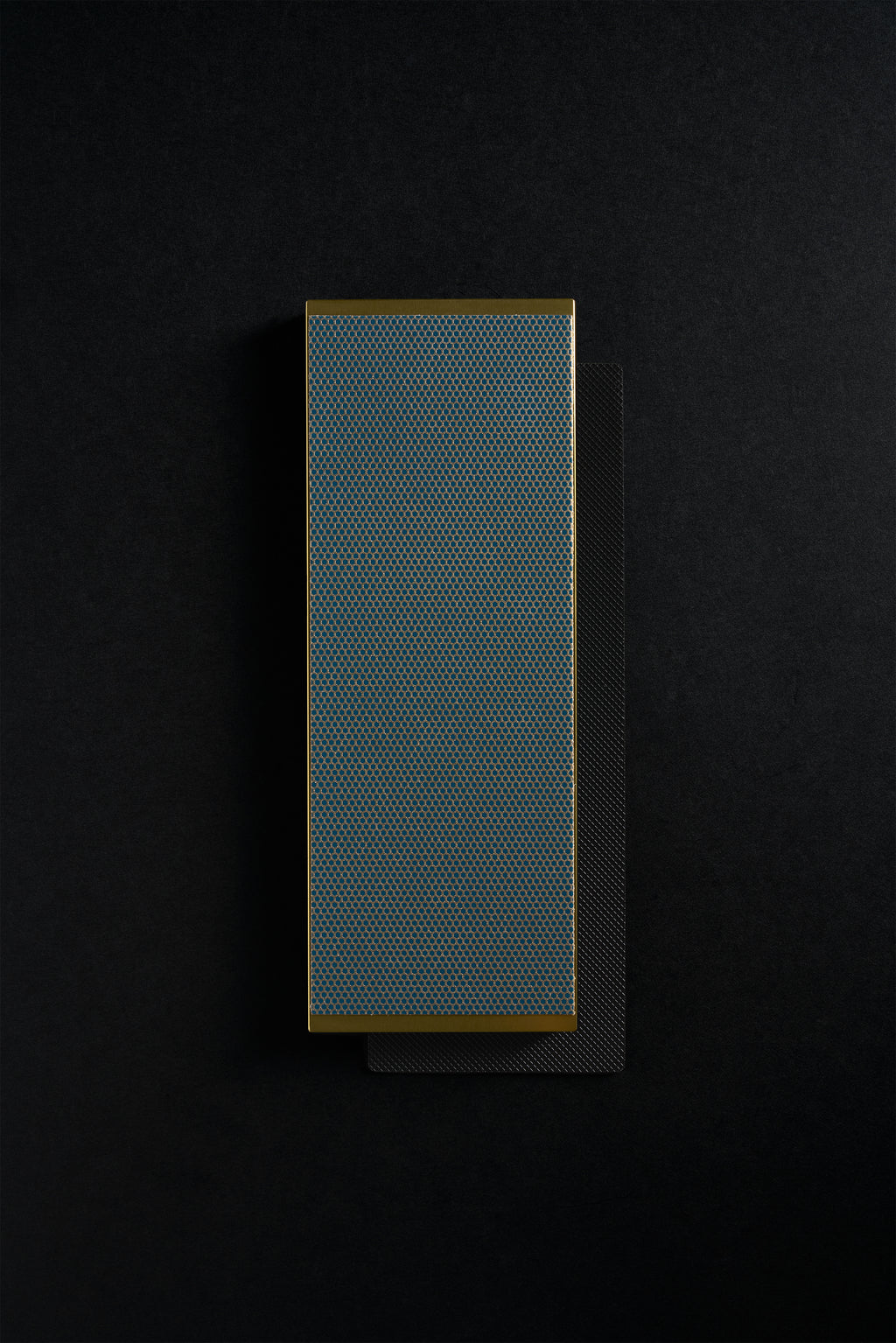 Gold Zen-Wu diamond flattening stone resting on a larger black stone