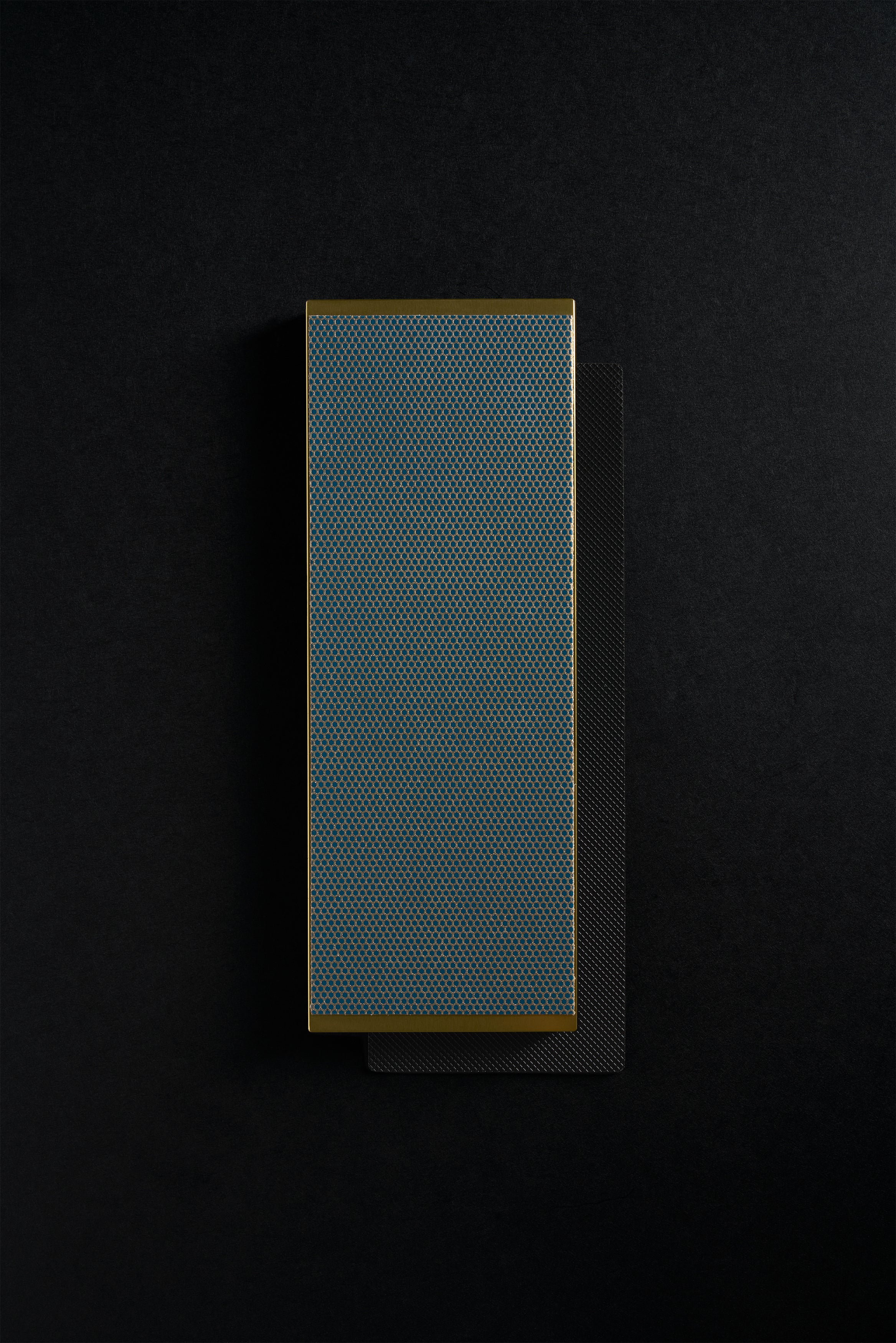 Gold Zen-Wu diamond flattening stone resting on a larger black stone