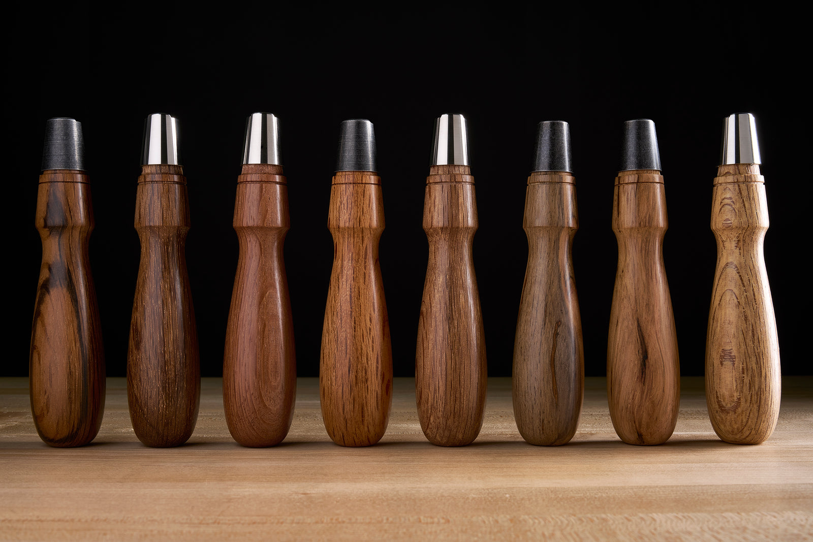 Eight red ring-cup oak chisel handles in a row, ranging from pale to nearly black