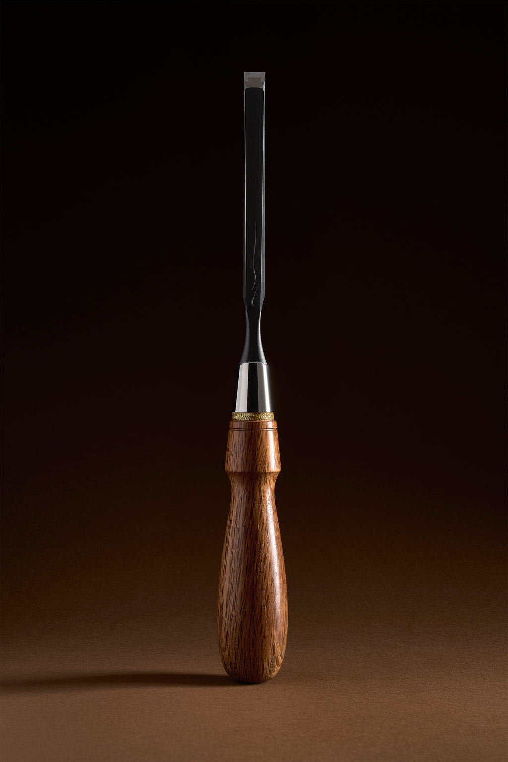 Narrow X-2 bench chisel upright, black titanium body and red bamboo-leaf oak handle