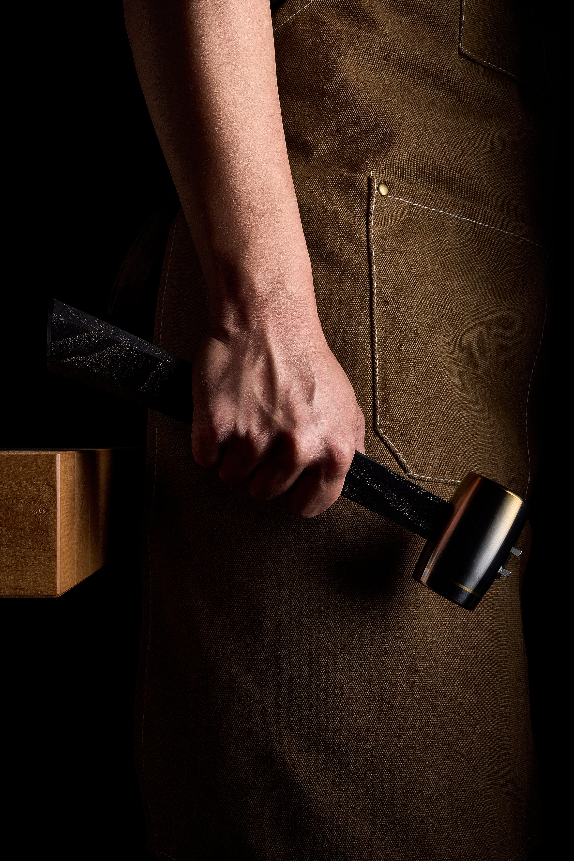 F-4 hammer held at the side, dyed hickory handle in hand