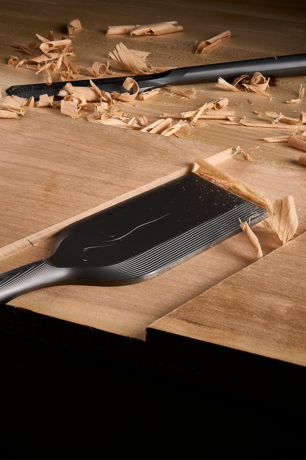 DC-1 paring chisel paring a joint, shavings gathered on the board around it