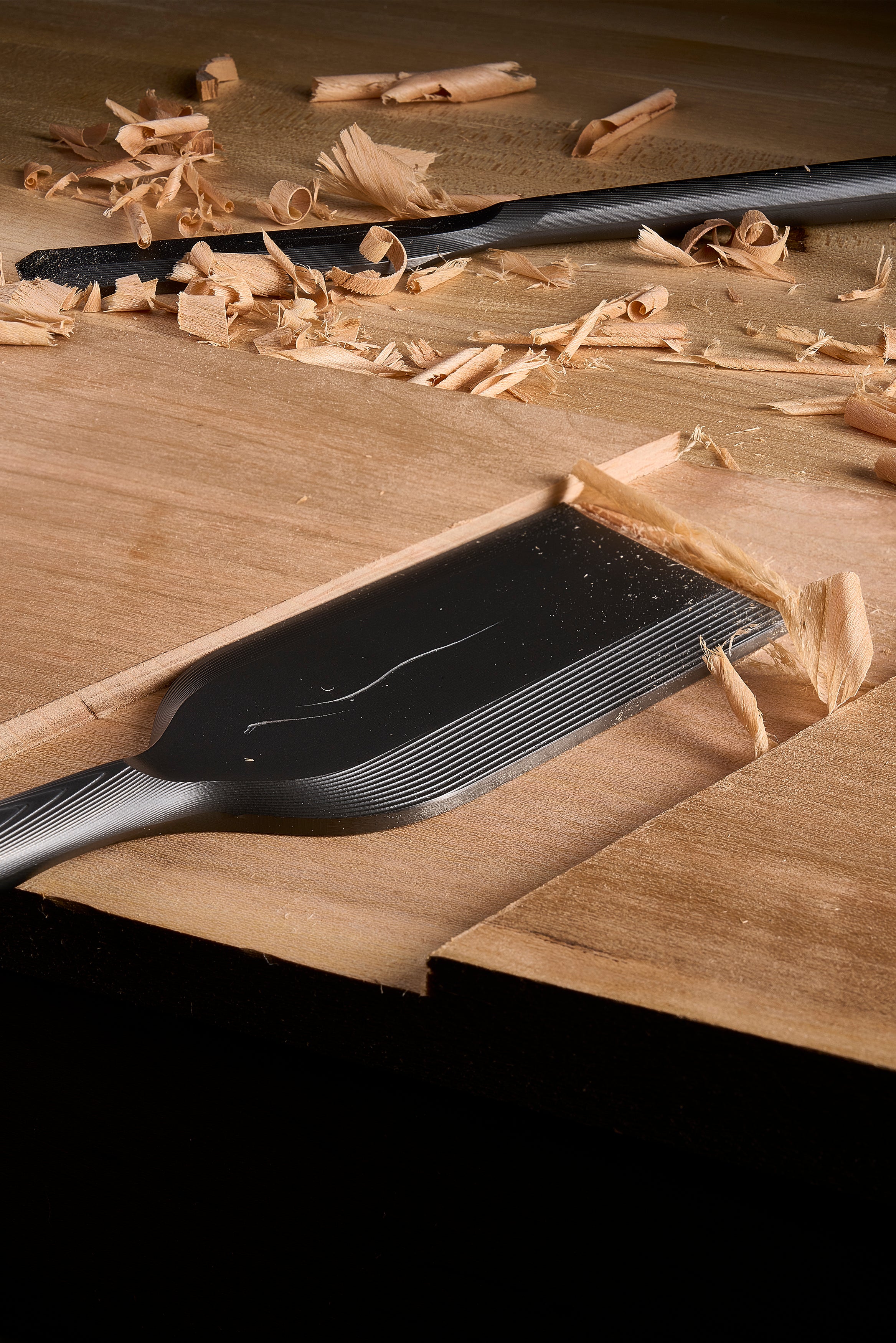 DC-1 paring chisel paring a joint, shavings gathered on the board around it