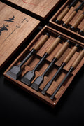 Five TB-1 timber framing chisels lying in a fitted wooden box, lid set aside