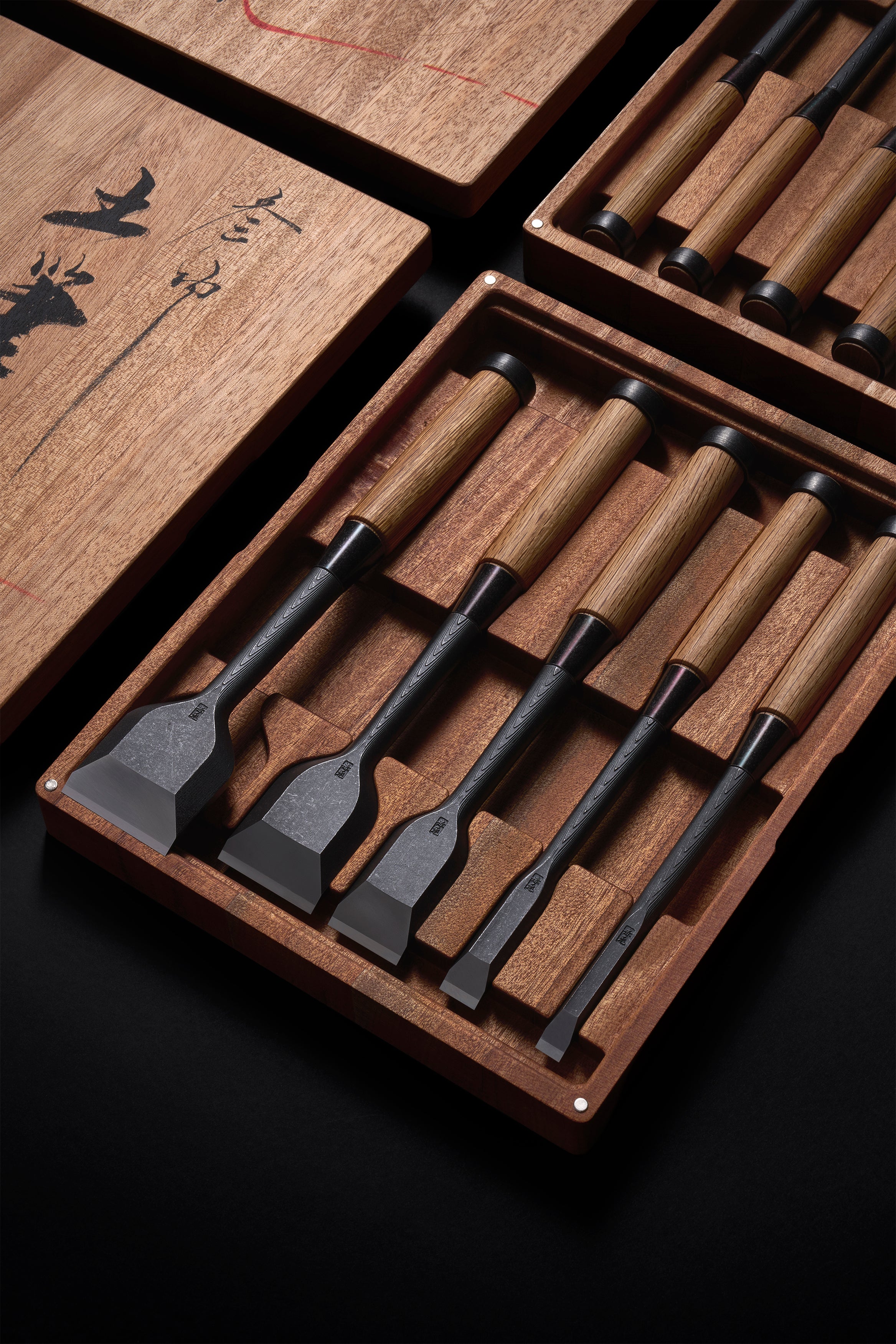 Five TB-1 timber framing chisels lying in a fitted wooden box, lid set aside