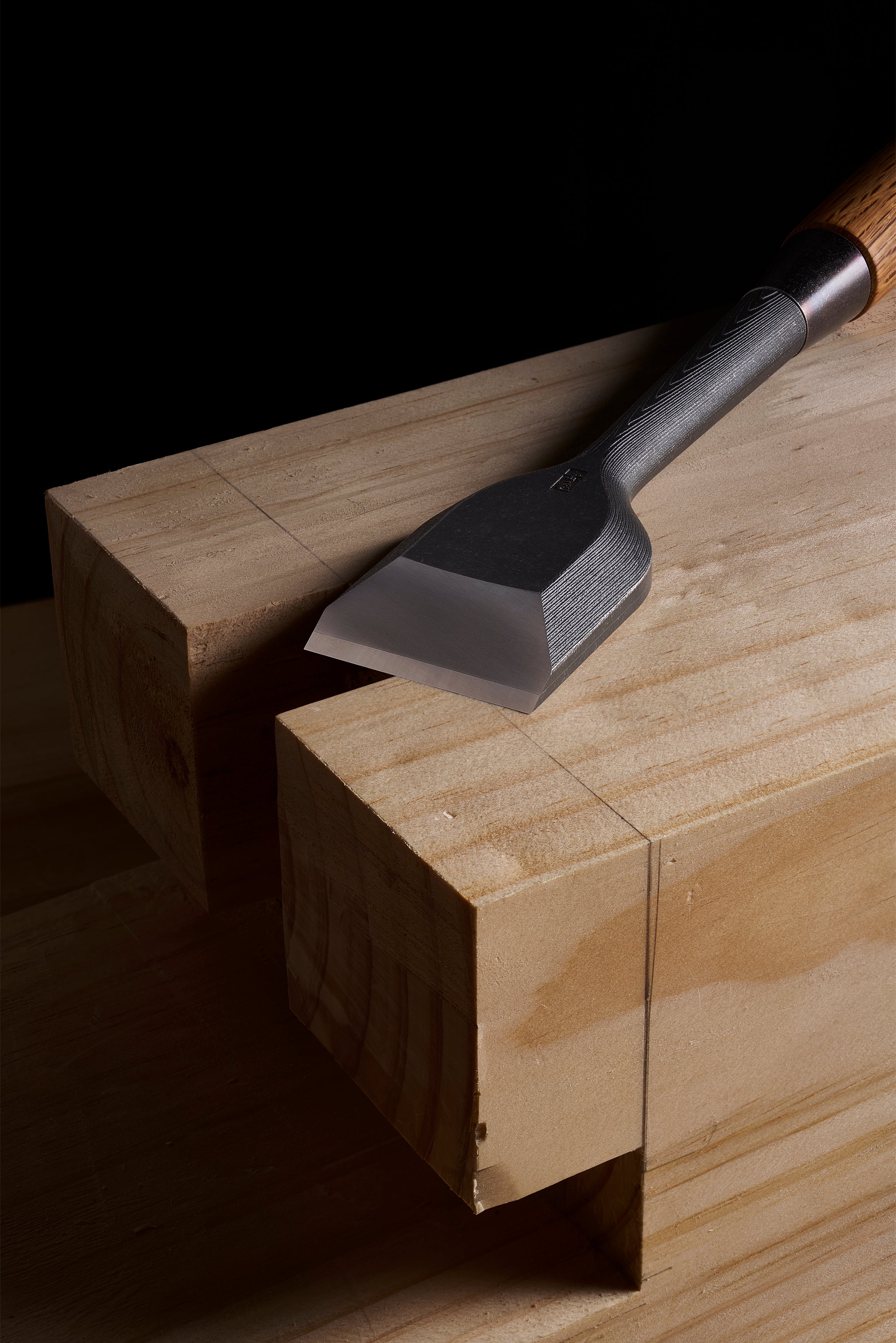 Wide TB-1 chisel resting on the shoulder cut of a squared timber