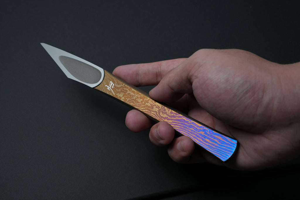 In hand, blade forward